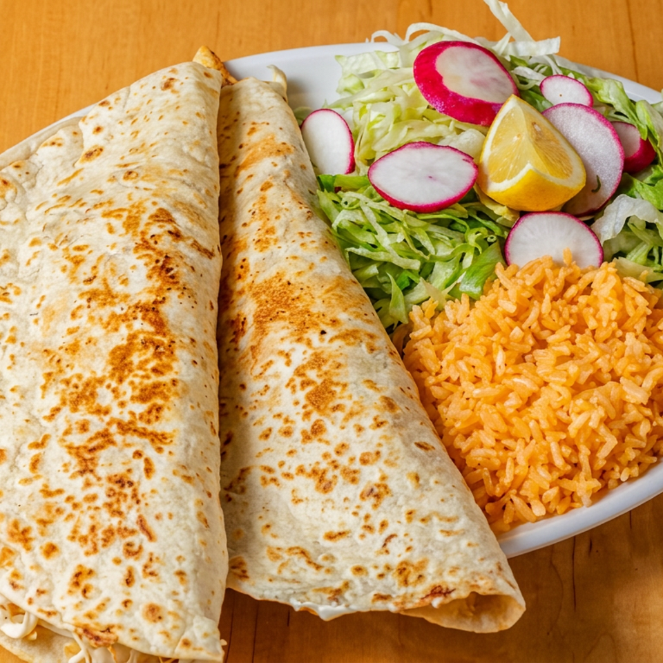 Two grilled flour tortillas served with orange rice, shredded lettuce, radishes, and lemon wedges on a white plate.